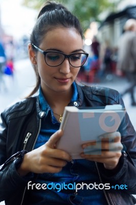 Beautiful Young Woman Reading A Book In The Street Stock Photo