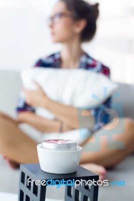 Beautiful Young Woman Relaxing On Sofa At Home Stock Photo