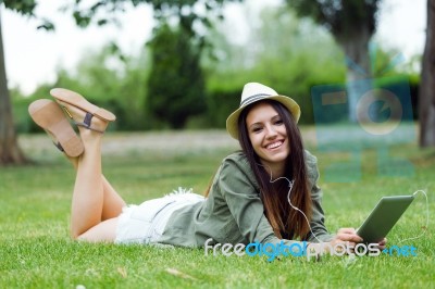 Beautiful Young Woman Using Digital Tablet In The Park Stock Photo