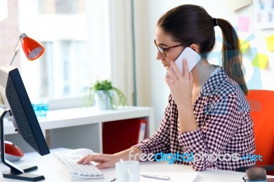 Beautiful Young Woman Using Her Laptop In The Office Stock Photo