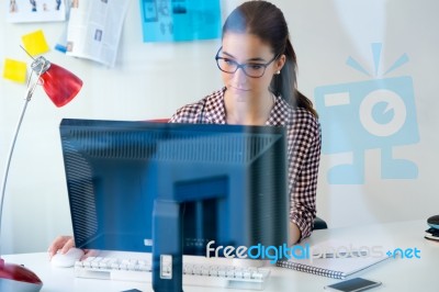 Beautiful Young Woman Using Her Laptop In The Office Stock Photo