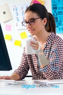 Beautiful Young Woman Using Her Laptop In The Office Stock Photo