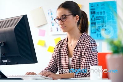 Beautiful Young Woman Using Her Laptop In The Office Stock Photo