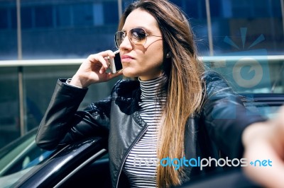 Beautiful Young Woman Using Her Mobile Phone In The Car Stock Photo