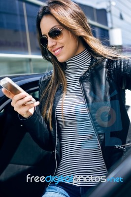 Beautiful Young Woman Using Her Mobile Phone In The Car Stock Photo