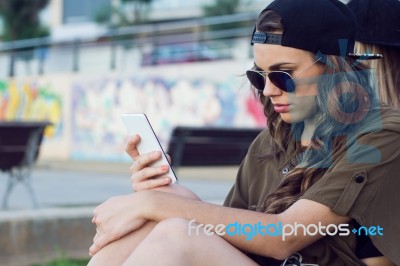 Beautiful Young Woman Using Her Mobile Phone In The Street Stock Photo