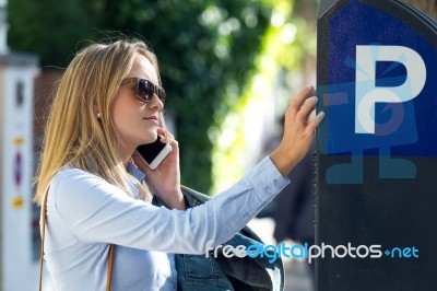 Beautiful Young Woman Using Her Mobile Phone In The Street Stock Photo