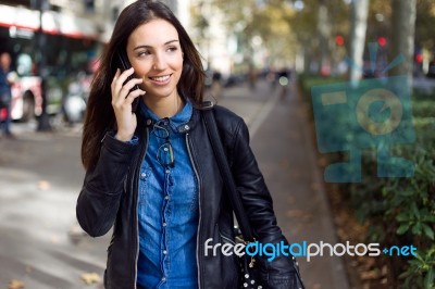 Beautiful Young Woman Using Her Mobile Phone In The Street Stock Photo