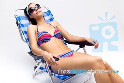 Beautiful Young Woman With Bikini Sitting On A Beach Chair Stock Photo