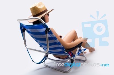 Beautiful Young Woman With Bikini Sitting On A Beach Chair Stock Photo