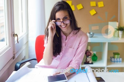 Beautiful Young Woman Working In Her Office Stock Photo