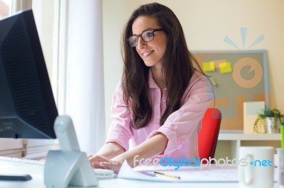 Beautiful Young Woman Working In Her Office Stock Photo