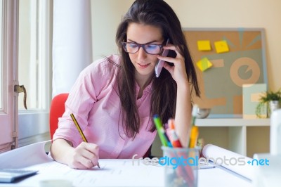 Beautiful Young Woman Working In Her Office Stock Photo