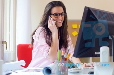 Beautiful Young Woman Working In Her Office Stock Photo