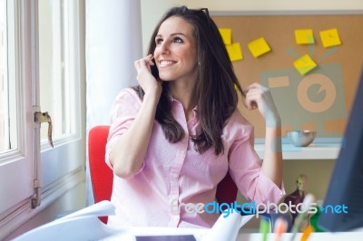 Beautiful Young Woman Working In Her Office Stock Photo