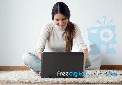 Beautiful Young Woman Working On Her Laptop At Home Stock Photo