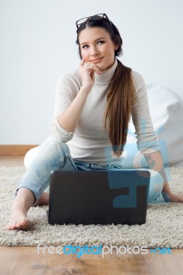 Beautiful Young Woman Working On Her Laptop At Home Stock Photo