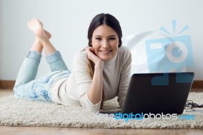 Beautiful Young Woman Working On Her Laptop At Home Stock Photo