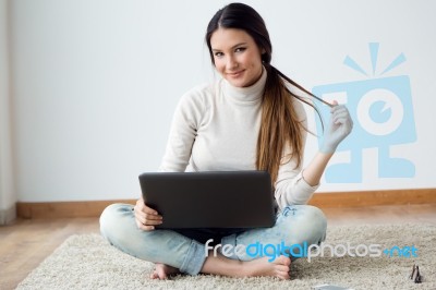 Beautiful Young Woman Working On Her Laptop At Home Stock Photo