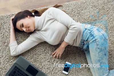 Beautiful Young Woman Working On Her Laptop At Home Stock Photo