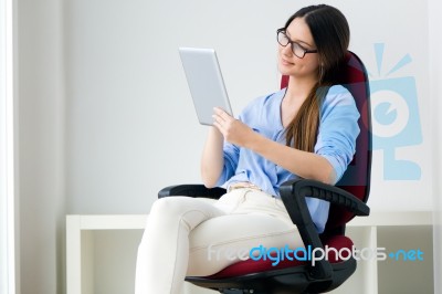 Beautiful Young Woman Working With Digital Tablet Stock Photo