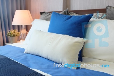 Bedroom With Pillows And Desk Lamp Stock Photo