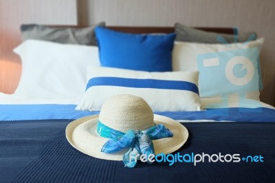 Bedroom With Pillows And Hat Stock Photo