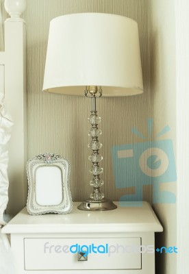 Bedside Table With Lamp, And Picture Frame Stock Photo