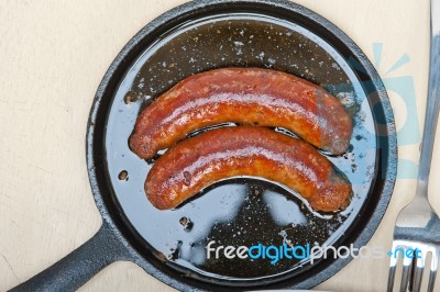 Beef Sausages Cooked On Iron Skillet Stock Photo