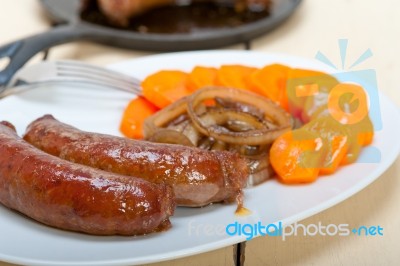 Beef Sausages Cooked On Iron Skillet Stock Photo