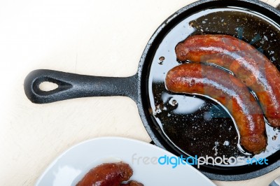 Beef Sausages Cooked On Iron Skillet Stock Photo