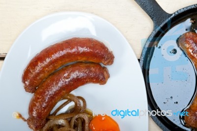 Beef Sausages Cooked On Iron Skillet Stock Photo