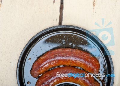 Beef Sausages Cooked On Iron Skillet Stock Photo