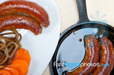 Beef Sausages Cooked On Iron Skillet Stock Photo