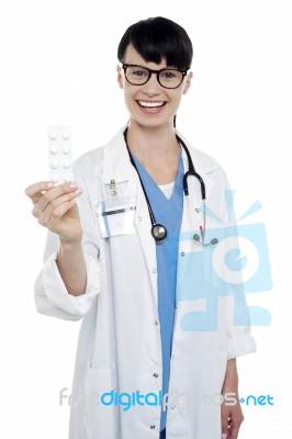 Bespectacled Duty Doctor Showing Medicine Strip Stock Photo