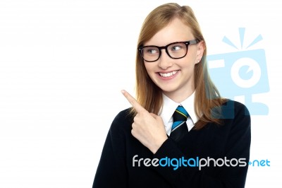 Bespectacled Smiling Student Pointing Away Stock Photo