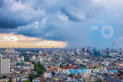 Big City With Rain Cloud Falling Stock Photo