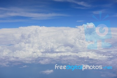 Big White Cloud And Blue Sky Background,view From Airplane Stock Photo