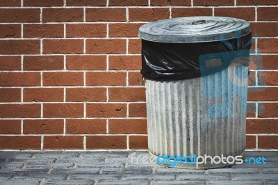 Bin And Brick Wall Stock Photo