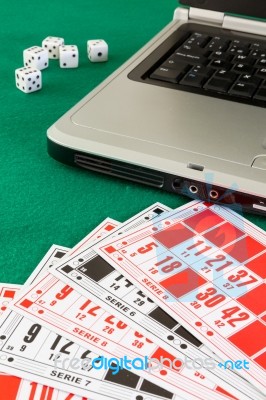 Bingo Cards On Casino Baize And A Laptop Stock Photo