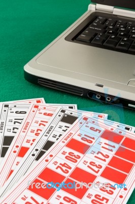 Bingo Cards On Casino Baize And A Laptop Stock Photo