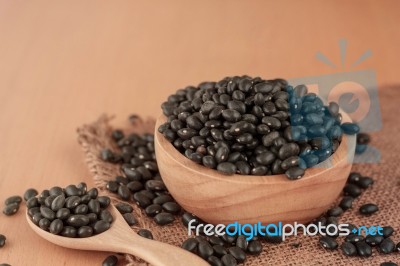 Black Beans On Wooden Floor Stock Photo