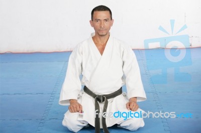 Black Belt Karate Man Sit On A Position To Start Or Finish Pract… Stock Photo