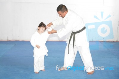 Black Belt Karate Teaching A Little Girl Stock Photo