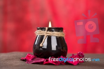 Black Candle Cup On Red Background Stock Photo