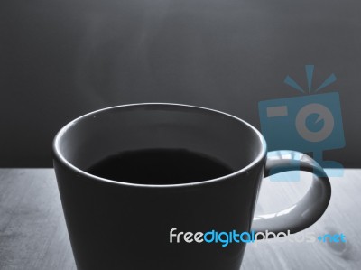 Black Coffee In White Ceramic Cup With Hot Smoke Floating Stock Photo