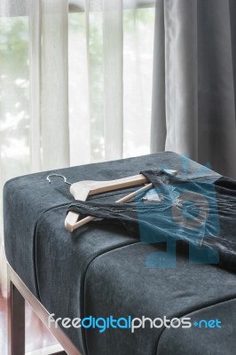 Black Dress With Wooden Coat Hanger Stock Photo