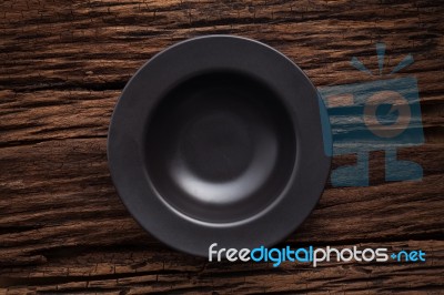 Black Empty Bowl On Wooden Table Background Stock Photo