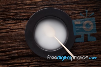 Black Empty Bowl Spoon On Wooden Table Background Stock Photo