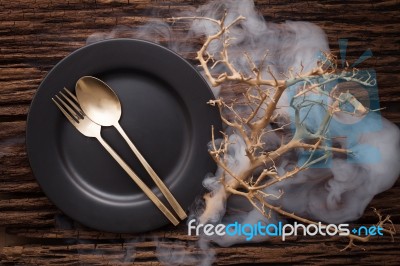 Black Empty Plate Fork Spoon On Wooden Table Background Stock Photo